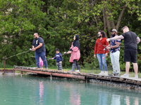 People are fishing for rainbow trout at a pond in Stouffville, Ontario, Canada, on May 12, 2024. (