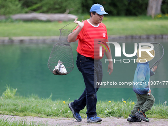 A man is holding a basket with freshly caught rainbow trout at a pond in Stouffville, Ontario, Canada, on May 12, 2024. (