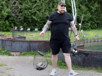 A man is holding a basket with freshly caught rainbow trout at a pond in Stouffville, Ontario, Canada, on May 12, 2024. (