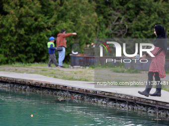 A woman is fishing for rainbow trout at a pond in Stouffville, Ontario, Canada, on May 12, 2024. (