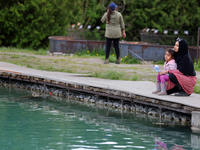 A woman and her daughter are fishing for rainbow trout at a pond in Stouffville, Ontario, Canada, on May 12, 2024. (