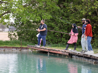 People are fishing for rainbow trout at a pond in Stouffville, Ontario, Canada, on May 12, 2024. (