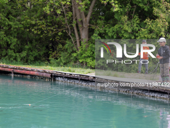 Children are fishing for rainbow trout at a pond in Stouffville, Ontario, Canada, on May 12, 2024. (