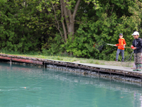 Children are fishing for rainbow trout at a pond in Stouffville, Ontario, Canada, on May 12, 2024. (