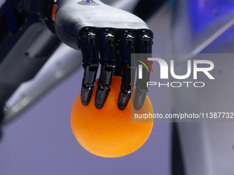 A hand from a humanoid robot is picking up a ball at the World Artificial Intelligence Conference at the Shanghai World Expo Exhibition Cent...