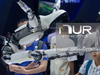 A humanoid robot is demonstrating how to move its hands and legs at the World Artificial Intelligence Conference at the Shanghai World Expo...