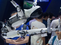 A humanoid robot is demonstrating how to move its hands and legs at the World Artificial Intelligence Conference at the Shanghai World Expo...