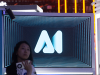 A visitor is walking past an AI sign at the World Artificial Intelligence Conference at the Shanghai World Expo Exhibition Center in Shangha...