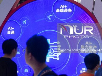 Visitors are walking past a sign of AI information at the World Artificial Intelligence Conference at the Shanghai World Expo Exhibition Cen...