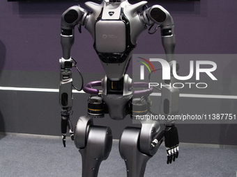 A humanoid robot is demonstrating how to walk and interact with people at the World Artificial Intelligence Conference at the Shanghai World...