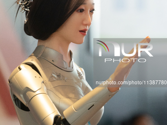 A humanoid robot, created by a team from Qingbao Robot, is greeting people at the World Artificial Intelligence Conference at the Shanghai W...