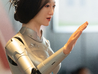 A humanoid robot, created by a team from Qingbao Robot, is greeting people at the World Artificial Intelligence Conference at the Shanghai W...