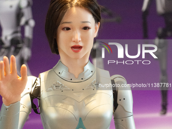 A humanoid robot, created by a team from Qingbao Robot, is greeting people at the World Artificial Intelligence Conference at the Shanghai W...