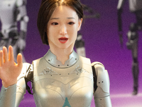 A humanoid robot, created by a team from Qingbao Robot, is greeting people at the World Artificial Intelligence Conference at the Shanghai W...