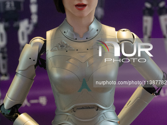 A humanoid robot, created by a team from Qingbao Robot, is greeting people at the World Artificial Intelligence Conference at the Shanghai W...