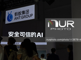 Visitors are being seen at the Ant Group stand at the World Artificial Intelligence Conference at the Shanghai World Expo Exhibition Center...