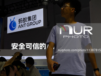 Visitors are being seen at the Ant Group stand at the World Artificial Intelligence Conference at the Shanghai World Expo Exhibition Center...