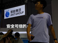 Visitors are being seen at the Ant Group stand at the World Artificial Intelligence Conference at the Shanghai World Expo Exhibition Center...