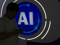 A visitor is walking past an AI sign at the World Artificial Intelligence Conference at the Shanghai World Expo Exhibition Center in Shangha...