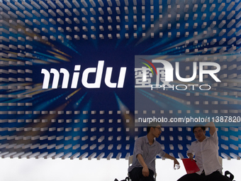 Visitors are being seen in front of the Midu stand at the World Artificial Intelligence Conference at the Shanghai World Expo Exhibition Cen...