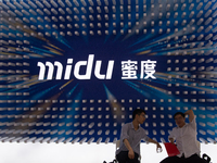 Visitors are being seen in front of the Midu stand at the World Artificial Intelligence Conference at the Shanghai World Expo Exhibition Cen...