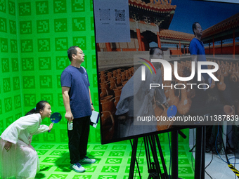 Visitors are standing in front of a green screen with AI backgrounds at the World Artificial Intelligence Conference at the Shanghai World E...