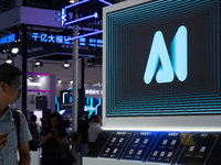 A visitor is walking past an AI sign at the World Artificial Intelligence Conference at the Shanghai World Expo Exhibition Center in Shangha...