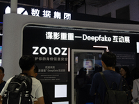 Visitors are checking the information on how to protect from Deepfake information at the Alibaba stand at the World Artificial Intelligence...