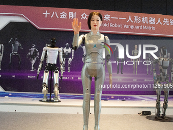 A humanoid robot, created by a team from Qingbao Robot, is greeting people at the World Artificial Intelligence Conference at the Shanghai W...