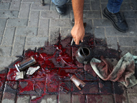 A man is working for the United Nations Relief and Works Agency (URNWA) and is staring at the blood of a victim at the entrance of the agenc...