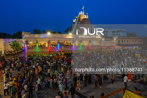 Many devotees are offering prayers at the Jagannath Temple on the eve of Lord Jagannath's 147th Rath Yatra in Ahmedabad, India, on Saturday....