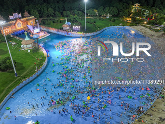 A large number of citizens are cooling off at a water park on the evening of high temperature in Nanjing, China, on July 6, 2024. (