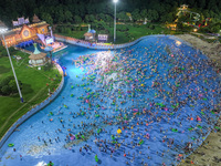 A large number of citizens are cooling off at a water park on the evening of high temperature in Nanjing, China, on July 6, 2024. (