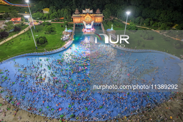 A large number of citizens are cooling off at a water park on the evening of high temperature in Nanjing, China, on July 6, 2024. 