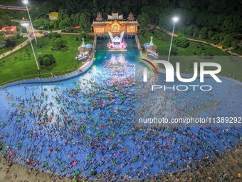 A large number of citizens are cooling off at a water park on the evening of high temperature in Nanjing, China, on July 6, 2024. (