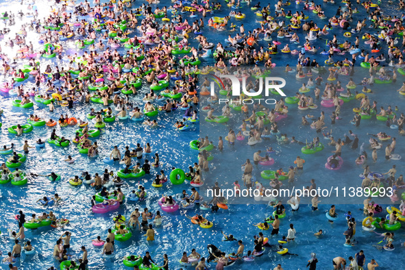 A large number of citizens are cooling off at a water park on the evening of high temperature in Nanjing, China, on July 6, 2024. 