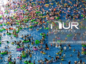 A large number of citizens are cooling off at a water park on the evening of high temperature in Nanjing, China, on July 6, 2024. (