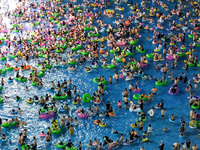 A large number of citizens are cooling off at a water park on the evening of high temperature in Nanjing, China, on July 6, 2024. (