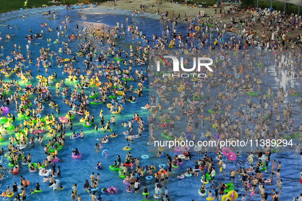 A large number of citizens are cooling off at a water park on the evening of high temperature in Nanjing, China, on July 6, 2024. 