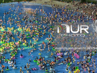 A large number of citizens are cooling off at a water park on the evening of high temperature in Nanjing, China, on July 6, 2024. (