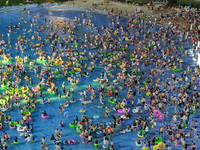 A large number of citizens are cooling off at a water park on the evening of high temperature in Nanjing, China, on July 6, 2024. (