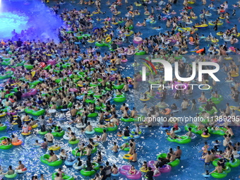 A large number of citizens are cooling off at a water park on the evening of high temperature in Nanjing, China, on July 6, 2024. (