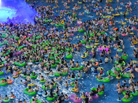 A large number of citizens are cooling off at a water park on the evening of high temperature in Nanjing, China, on July 6, 2024. (