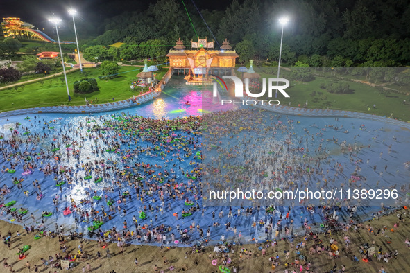 A large number of citizens are cooling off at a water park on the evening of high temperature in Nanjing, China, on July 6, 2024. 