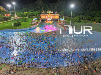 A large number of citizens are cooling off at a water park on the evening of high temperature in Nanjing, China, on July 6, 2024. (