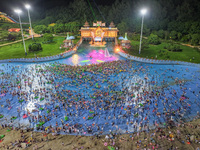 A large number of citizens are cooling off at a water park on the evening of high temperature in Nanjing, China, on July 6, 2024. (