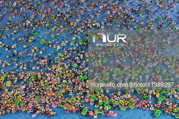 A large number of citizens are cooling off at a water park on the evening of high temperature in Nanjing, China, on July 6, 2024. 