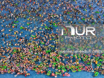 A large number of citizens are cooling off at a water park on the evening of high temperature in Nanjing, China, on July 6, 2024. (