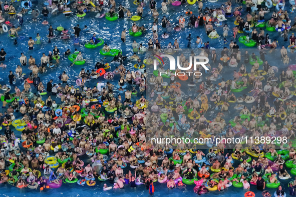 A large number of citizens are cooling off at a water park on the evening of high temperature in Nanjing, China, on July 6, 2024. 