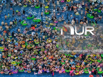 A large number of citizens are cooling off at a water park on the evening of high temperature in Nanjing, China, on July 6, 2024. (